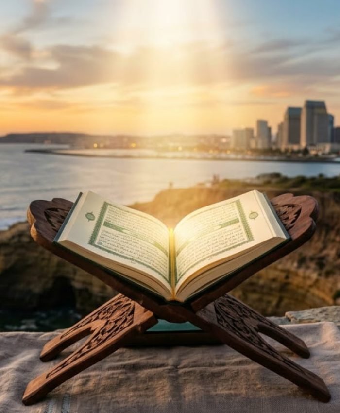 An open Quran on a wooden stand illuminated by a soft golden beam of light, set against a peaceful, blurred San Diego sunset background, symbolizing a spiritual journey to Islam.
